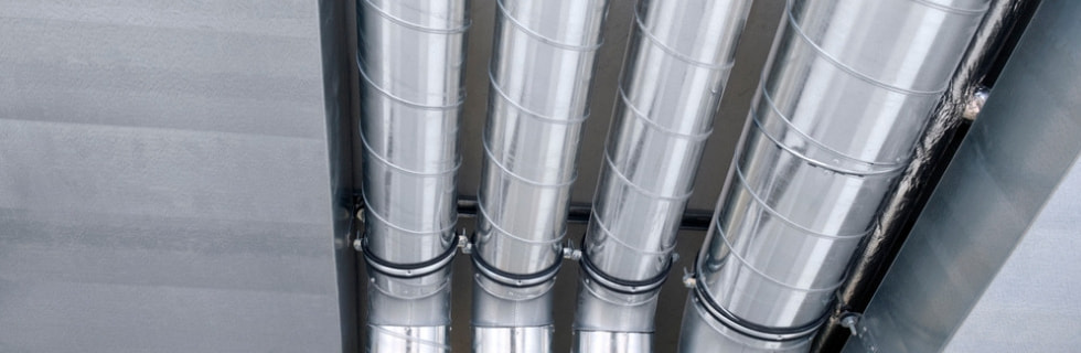 Metal air ducts in a ceiling, showcasing HVAC system components for improved indoor air quality and system efficiency.
